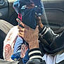 Chōzyn is registered to the contest to win money with this photo: baby, child, hands, car_interior, clothing, blue_pajamas, window, sunlight, person, sitting, arm, adult, jacket, striped_cuffs, blanket, seat, casual, holding, indoor, playful