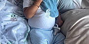 Chōzyn joined the competition — help win amazing prizes! baby, infant, smile, happy, blue_stripes, hat, bracelet, pacifier, blanket, soft, cozy, bed, pillow, child, cute, clothing, lying_down, indoors, playful, young