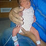 Mireya is registered to the contest to win money with this photo: newborn, baby, infant, hospital, medical, monitoring, nasal_tube, adult_hand, blue_shirt, jeans, bed, medical_equipment, indoor, person, holding, legs, clothing, skin, healthcare, patient