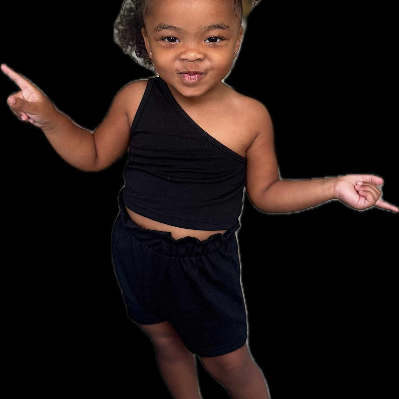 Nuri is registered to the contest to win money with this photo: black_background, black_shorts, black_top, child, confident, curly_hair, cute, earrings, fashion, girl, happy, person, playful, portrait, posing, sandals, smile, standing, stylish, youth