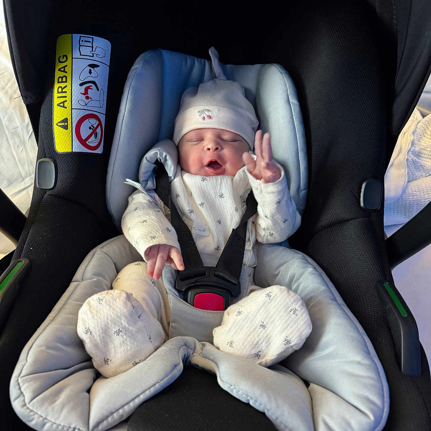 Baby is registered to the contest to win money with this photo: baby, car, car_interior, carseat, clothing, crib, cushion, face, furniture, glove, hat, head, homedecor, infantbed, newborn, person, photography, portrait, transportation, vehicle