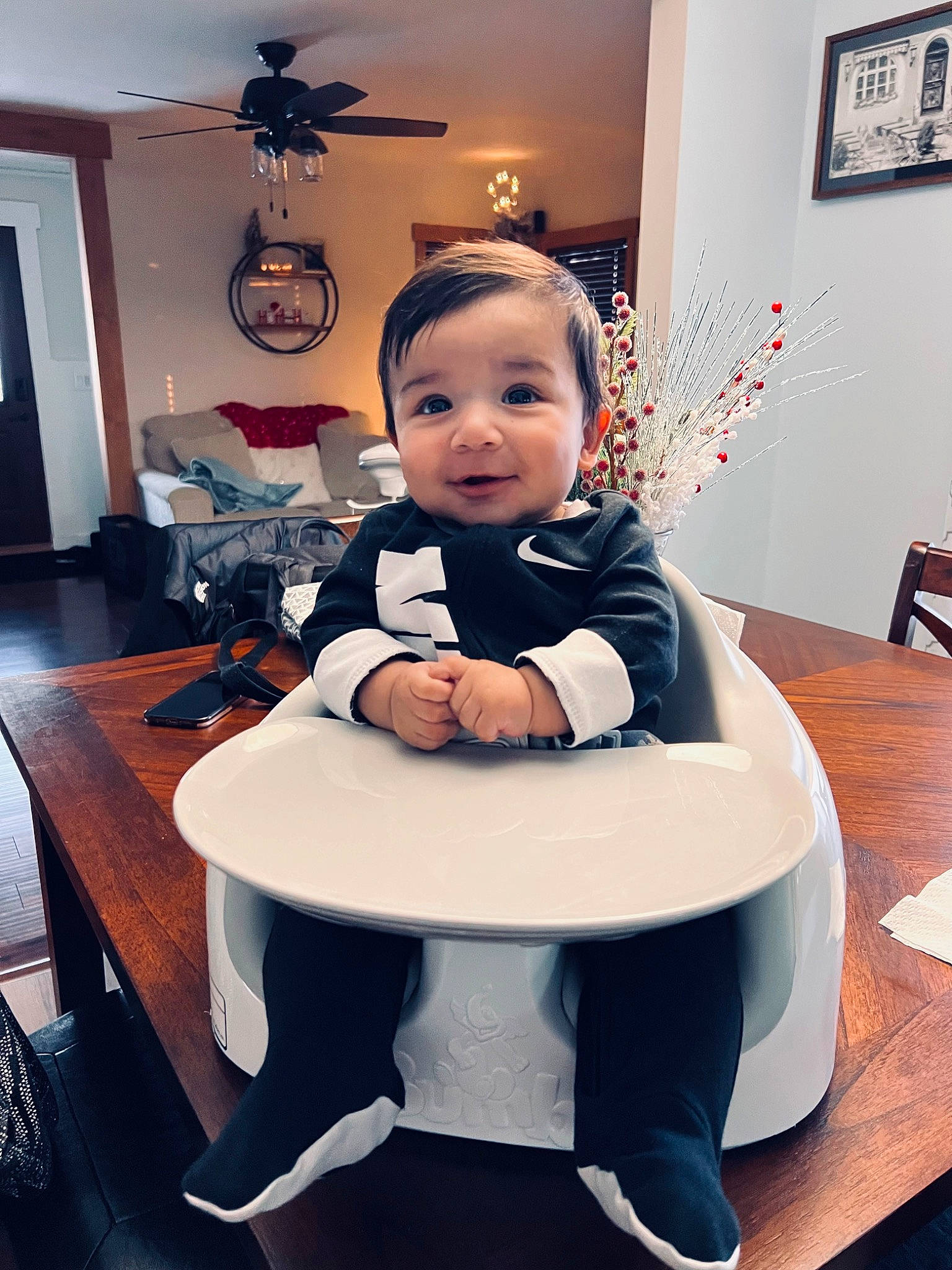 Aj is registered to the contest to win money with this photo: baby, baby_toddler_clothing, ceiling_fan, chair, child, comfort, flooring, furniture, hardwood, interior_design, lighting, lighting_accessory, living_room, mechanical_fan, person, picture_frame, room, sitting, table, toddler
