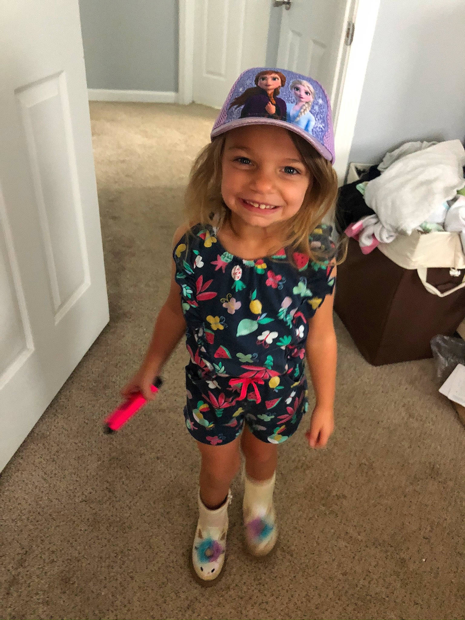 Emerie is registered to the contest to win money with this photo: arm, baby_toddler_clothing, baseball_cap, bicycle_helmet, cap, cool, door, fun, happy, headgear, headwear, helmet, human_body, joy, leg, person, shoulder, sleeve, smile, sneakers