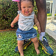 Myyahna is registered to the contest to win money with this photo: toddler, child, baby, grass, smiling, outdoor, denim_skirt, white_top, pigtails, barefoot, adult_legs, shoes, socks, greenery, sunlight, backyard, happy, cute, person, nature