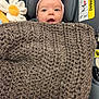 Mia joined the competition — help win amazing prizes! baby, child, car_seat, blanket, knit, headband, pink, flower_toy, face, expression, indoor, infant, cute, smile, warm, cozy, seatbelt, safety, young_child, portrait