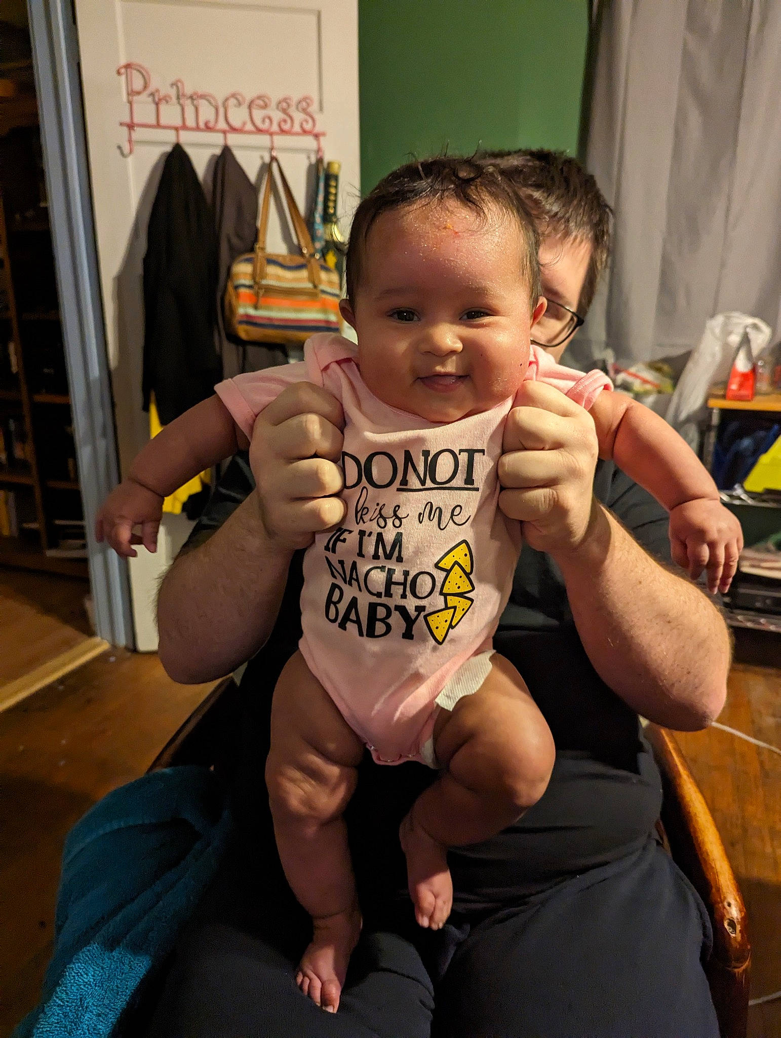 Moira is registered to the contest to win money with this photo: arm, baby, baby_toddler_clothing, chair, chest, elbow, finger, fun, gesture, hand, happy, joint, muscle, person, smile, sportswear, thigh, thumb, toddler, trunk