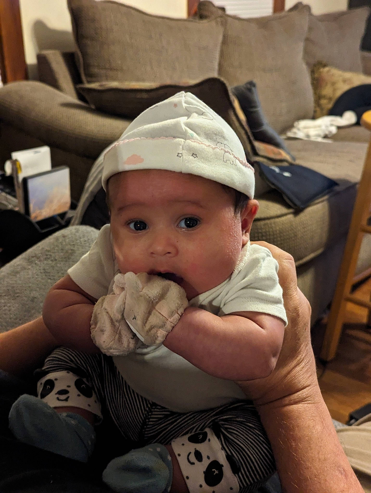 Moira joined the competition — help win amazing prizes! baby, baby_toddler_clothing, baseball_cap, cap, chair, cheek, child, comfort, couch, drinkware, fashion_accessory, happy, hat, headwear, lap, person, room, sitting, skin, t_shirt