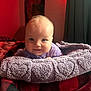 Vienna joined the competition — help win amazing prizes! baby, blanket, heart_pattern, purple, red, black, checkered, cozy, soft_texture, infant, face, smiling, indoors, curtains, warm_lighting, cute, portrait, clothing, head, person