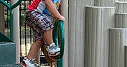 Jakarye joined the competition — help win amazing prizes! child, toddler, playground, climbing, steps, green_pole, braided_hair, sneakers, shorts, tshirt, outdoor, daylight, park, trees, fence, play_equipment, person, young_child, active, serious_expression