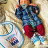 Jakarye joined the competition — help win amazing prizes! baby, newborn, pacifier, plaid_shirt, red_pants, blue_shoes, bib, blanket, sleeping, infant, cute, cozy, clothing, fabric, soft, baby_accessory, resting, indoors, person, cute_baby
