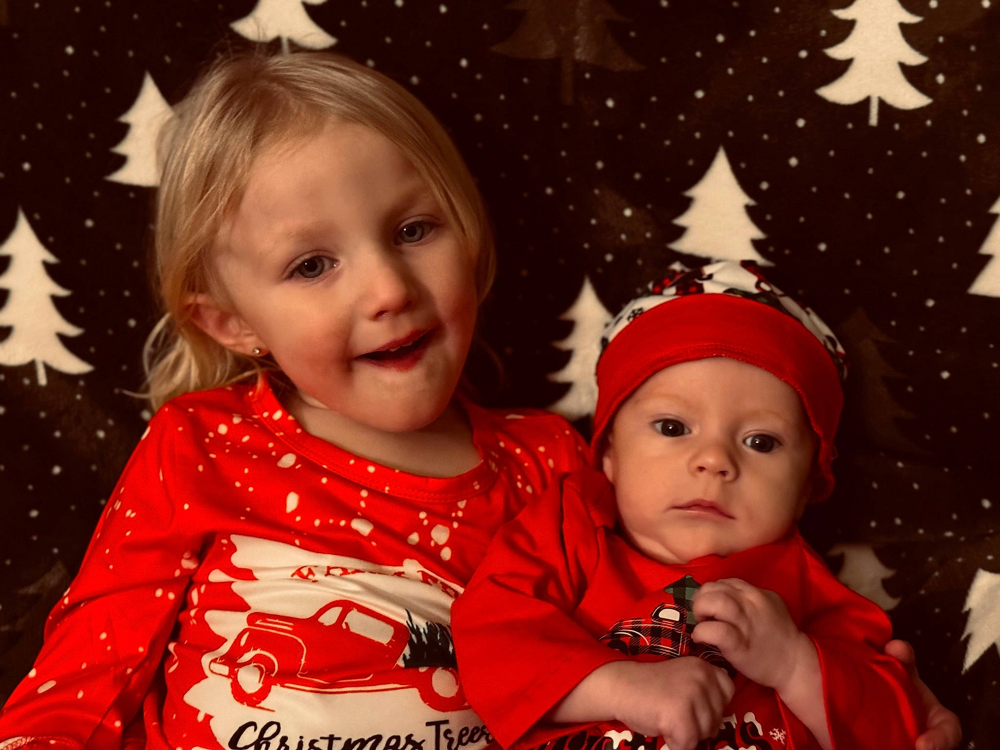 Paxton Shreve is registered to the contest to win money with this photo: baby, baby_toddler_clothing, beauty, child, christmas_decoration, christmas_ornament, christmas_tree, event, facial_expression, fun, happy, head, headwear, joy, organ, person, red, sleeve, smile, standing