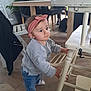 Camille a rejoint le concours — aidez-le/la à gagner de superbes lots ! toddler, child, headband, pink, sweater, jeans, white_chair, wooden_chair, indoor, floor, people, table, glass, drink, dog, curious, standing, home, casual_clothing, person