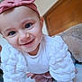 baby, child, smiling, crawling, headband, pink_bow, white_clothing, long_sleeves, indoor, face, cute, happy, closeup, person, infant, young_child, bright_eyes, soft_texture, warm_lighting, portrait