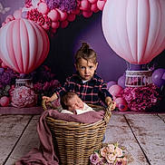 Louméa a rejoint le concours — aidez-le/la à gagner de superbes lots ! baby, basket, blanket, bouquet, child, flowers, floor, girl, happy, indoor, infant, person, plaid_shirt, portrait, purple, pink, props, toddler, wooden_floor, decor