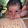 Louméa participe au concours pour gagner de l'argent avec cette photo : baby, infant, face, hands, shoulder, skin, person, outdoor, nature, greenery, portrait, closeup, cute, curious, expression, young, child, human, head, clothing