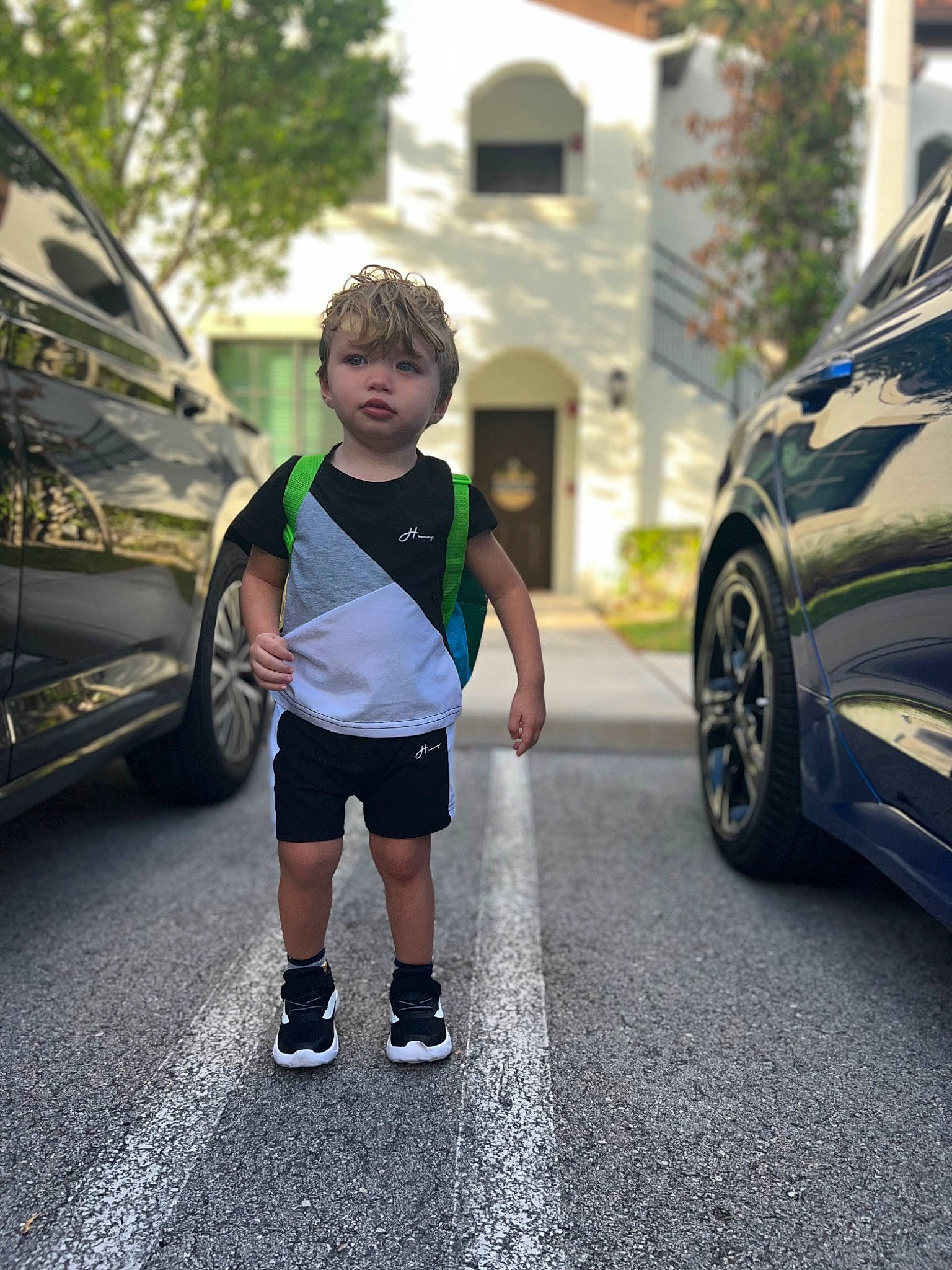 Alijah joined the competition — help win amazing prizes! asphalt, automotive_design, automotive_exterior, automotive_lighting, automotive_tire, automotive_wheel_system, bumper, car, electric_blue, motor_vehicle, person, road, road_surface, shorts, tints_and_shades, tire, toddler, tree, vehicle, vehicle_door