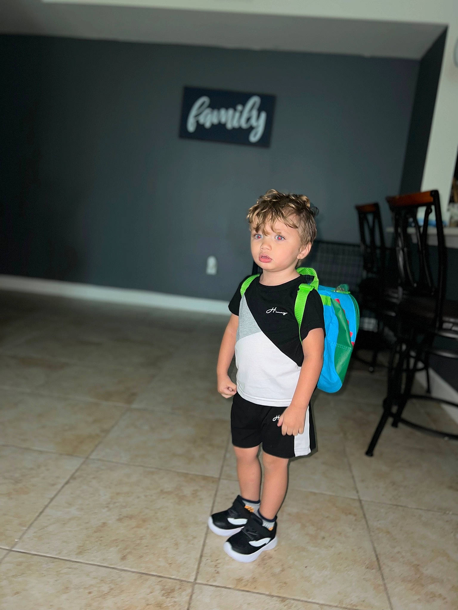 Alijah joined the competition — help win amazing prizes! chair, child, fashion_design, floor, flooring, fun, human_leg, knee, leg, leisure, person, recreation, room, shorts, sitting, sleeve, sock, sportswear, t_shirt, thigh