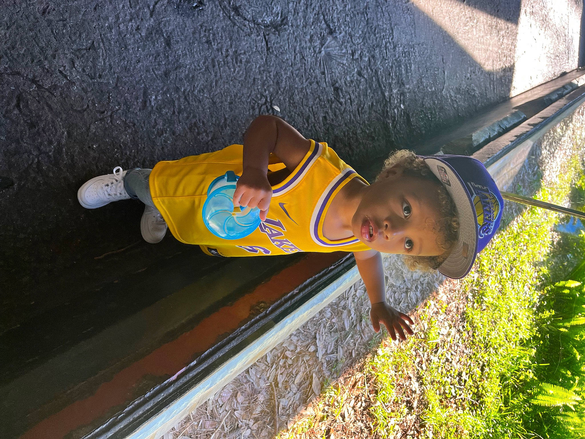 Kingston is registered to the contest to win money with this photo: asphalt, baby_toddler_clothing, child, concrete, electric_blue, fun, grass, happy, hat, leisure, person, plant, road_surface, smile, t_shirt, toddler, walking_shoe