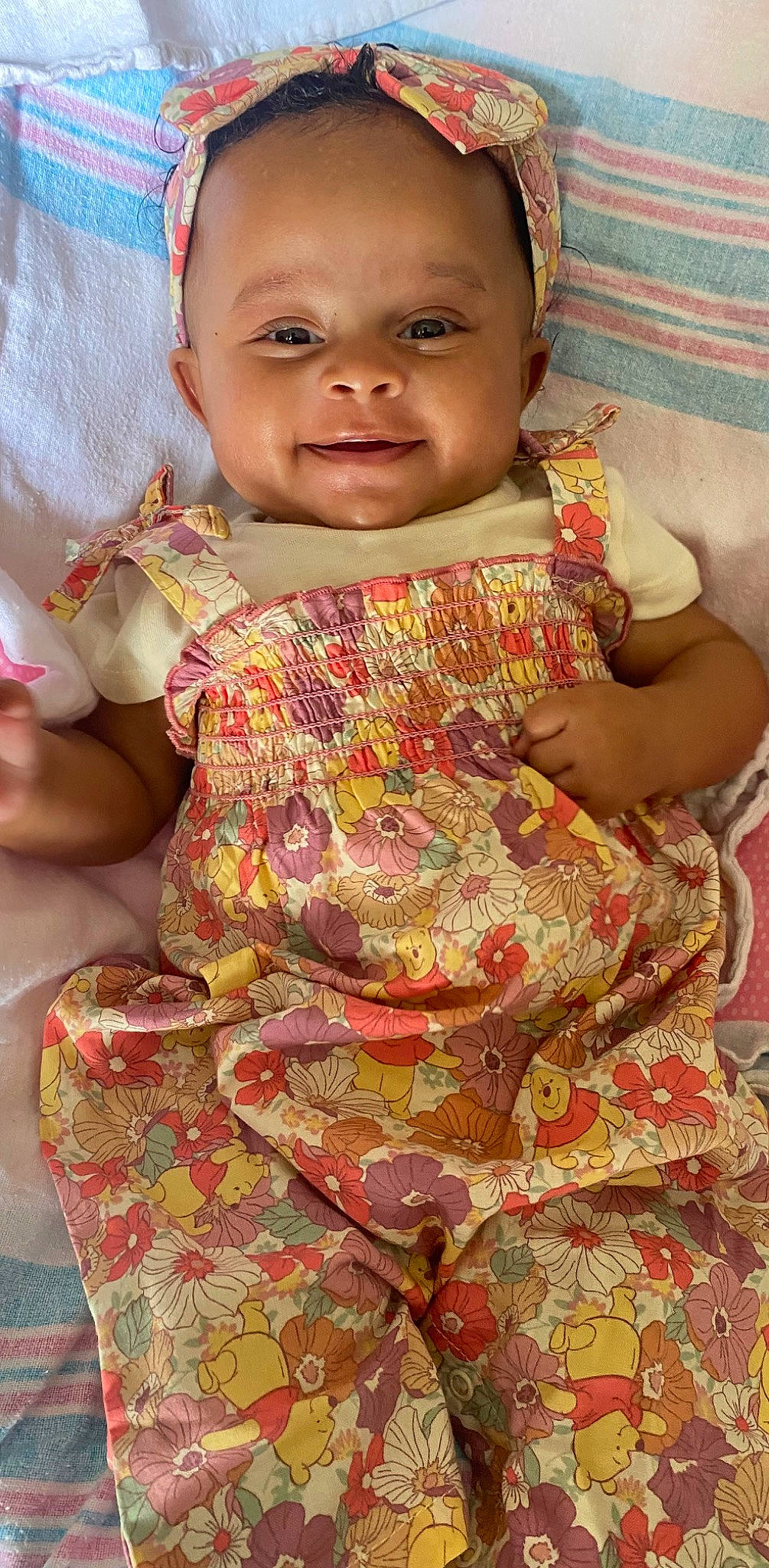 Kendall is registered to the contest to win money with this photo: arm, baby_toddler_clothing, cheek, child, eye, face, fun, hand, happy, head, pattern, person, sitting, skin, sleeve, smile, t_shirt, temple, textile, toddler