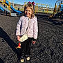 accessories, bag, child, clothing, coat, face, female, footwear, girl, handbag, head, jacket, outdoorplayarea, outdoors, person, playarea, shoe, slide, soil, toy