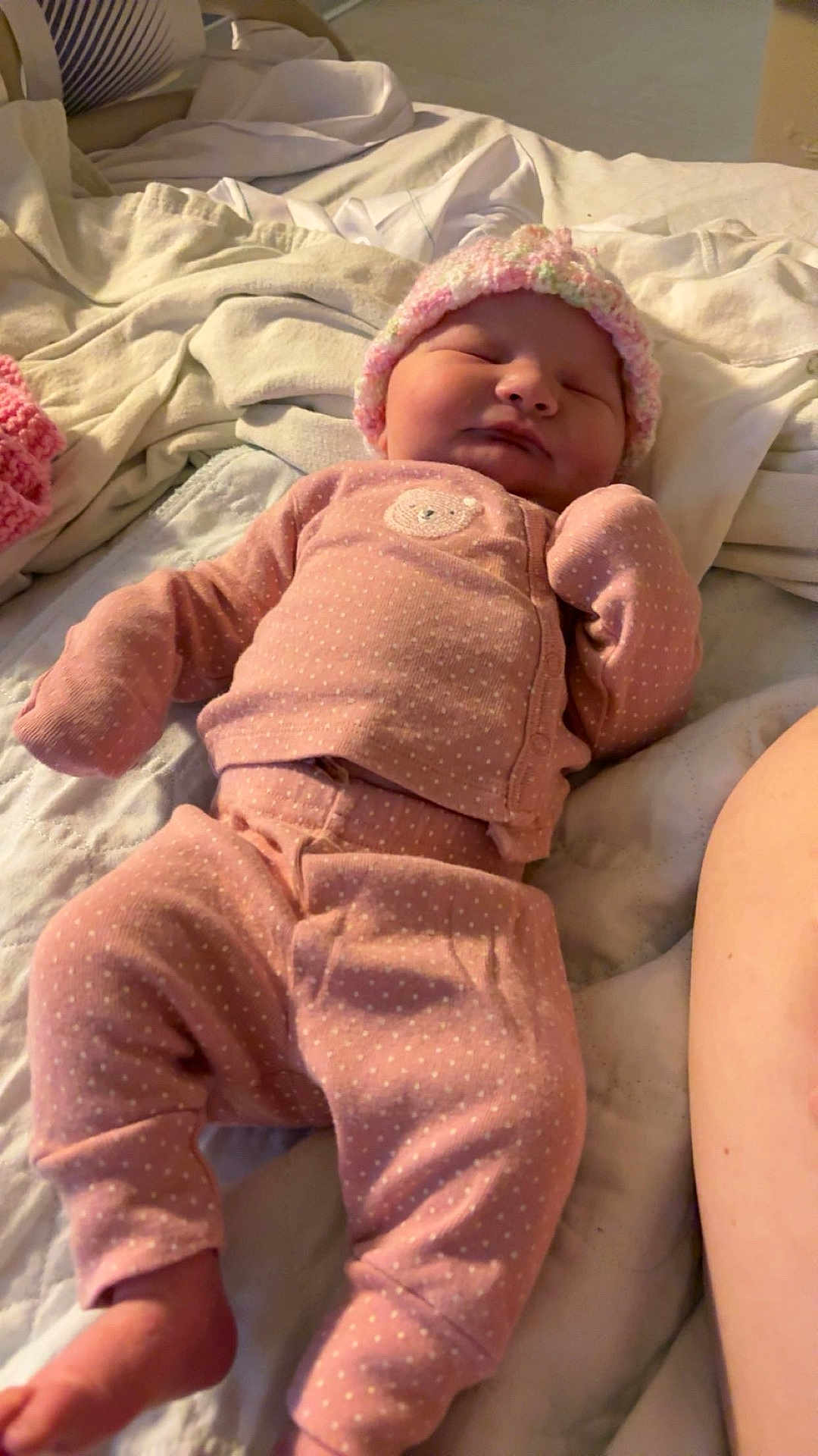 Bailey joined the competition — help win amazing prizes! newborn, baby, sleeping, pink_clothing, hat, bed, blanket, pajamas, infant, cozy, polka_dot, soft, cute, child, indoors, resting, peaceful, young, person, lying_down