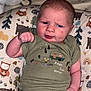 Bailey is registered to the contest to win money with this photo: animal_print, baby, bear, camping, child, cushion, cute, expression, face, fist, green_clothing, indoor, infant, onesie, owl, pattern, person, portrait, soft_toys, tree