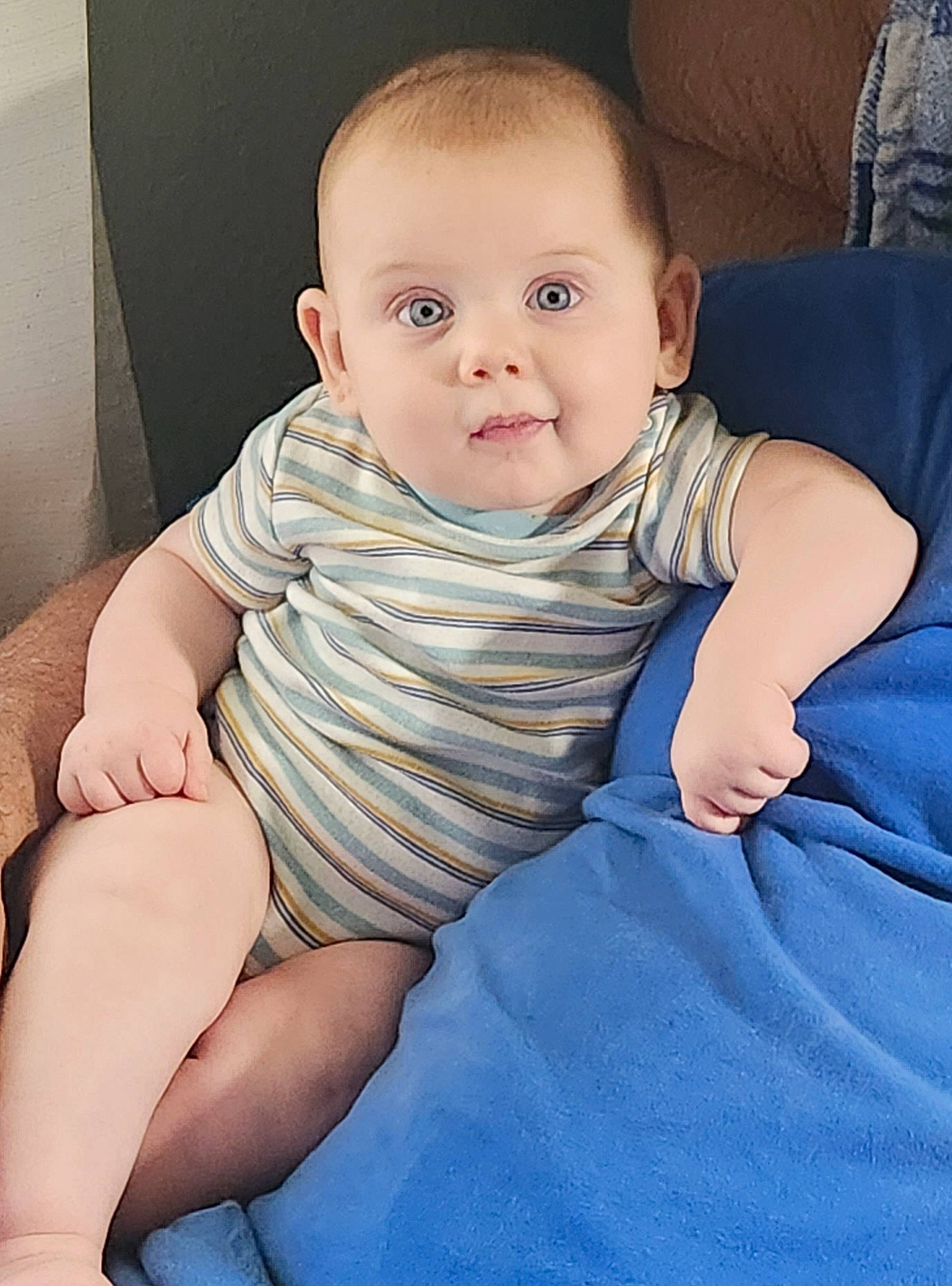 Jude is registered to the contest to win money with this photo: arm, baby_toddler_clothing, cheek, chin, comfort, eye, face, finger, hairstyle, hand, head, iris, mouth, neck, nose, person, shoulder, skin, sleeve, standing