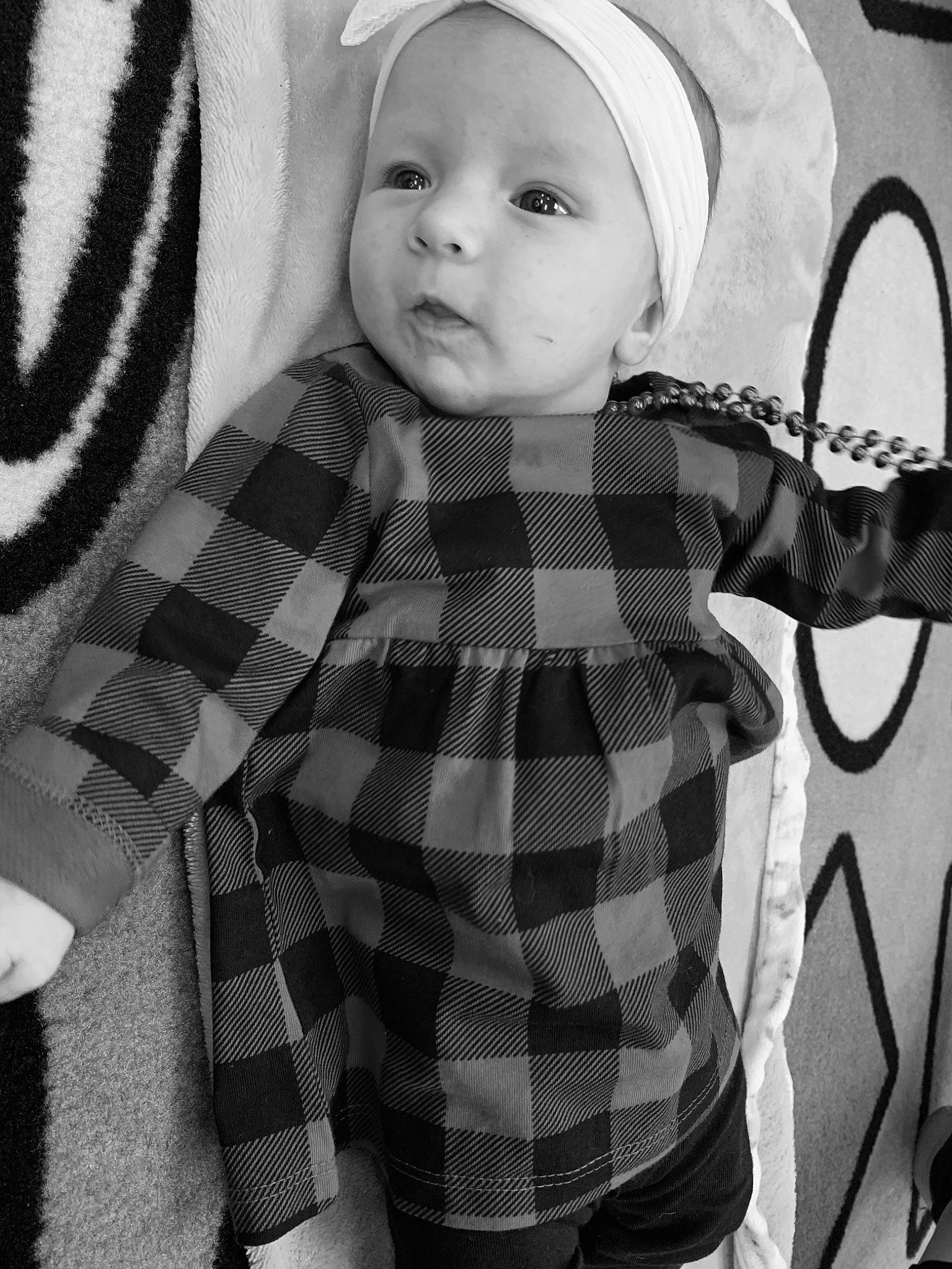 Aurora is registered to the contest to win money with this photo: baby, baby_toddler_clothing, black, black_and_white, child, collar, cool, eye, monochrome, pattern, person, photograph, plaid, sleeve, snapshot, standing, style, tartan, textile, toddler
