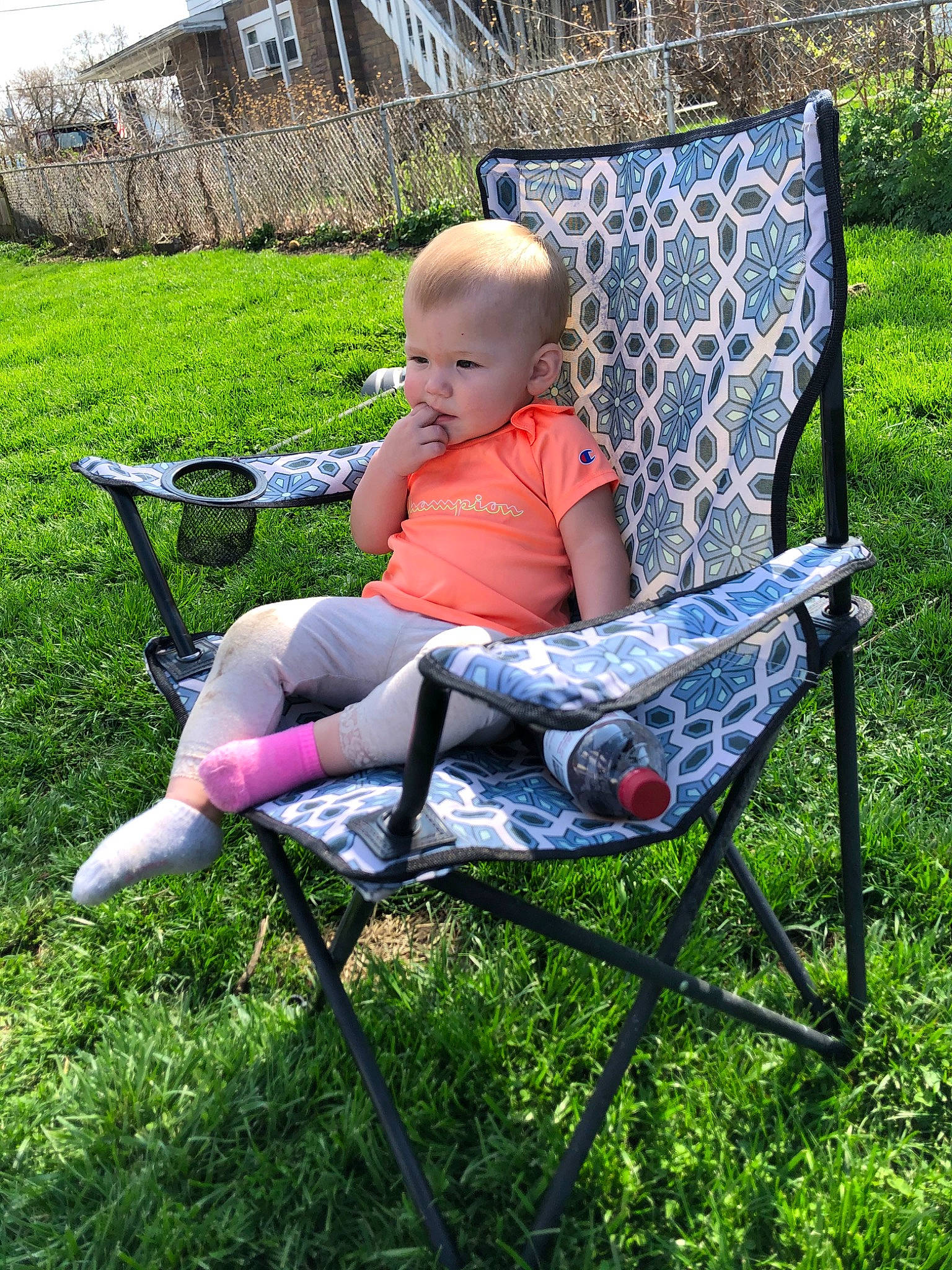 Ayla is registered to the contest to win money with this photo: chair, child, furniture, grass, lawn, leisure, outdoor_furniture, person, product, sitting, toddler, yard