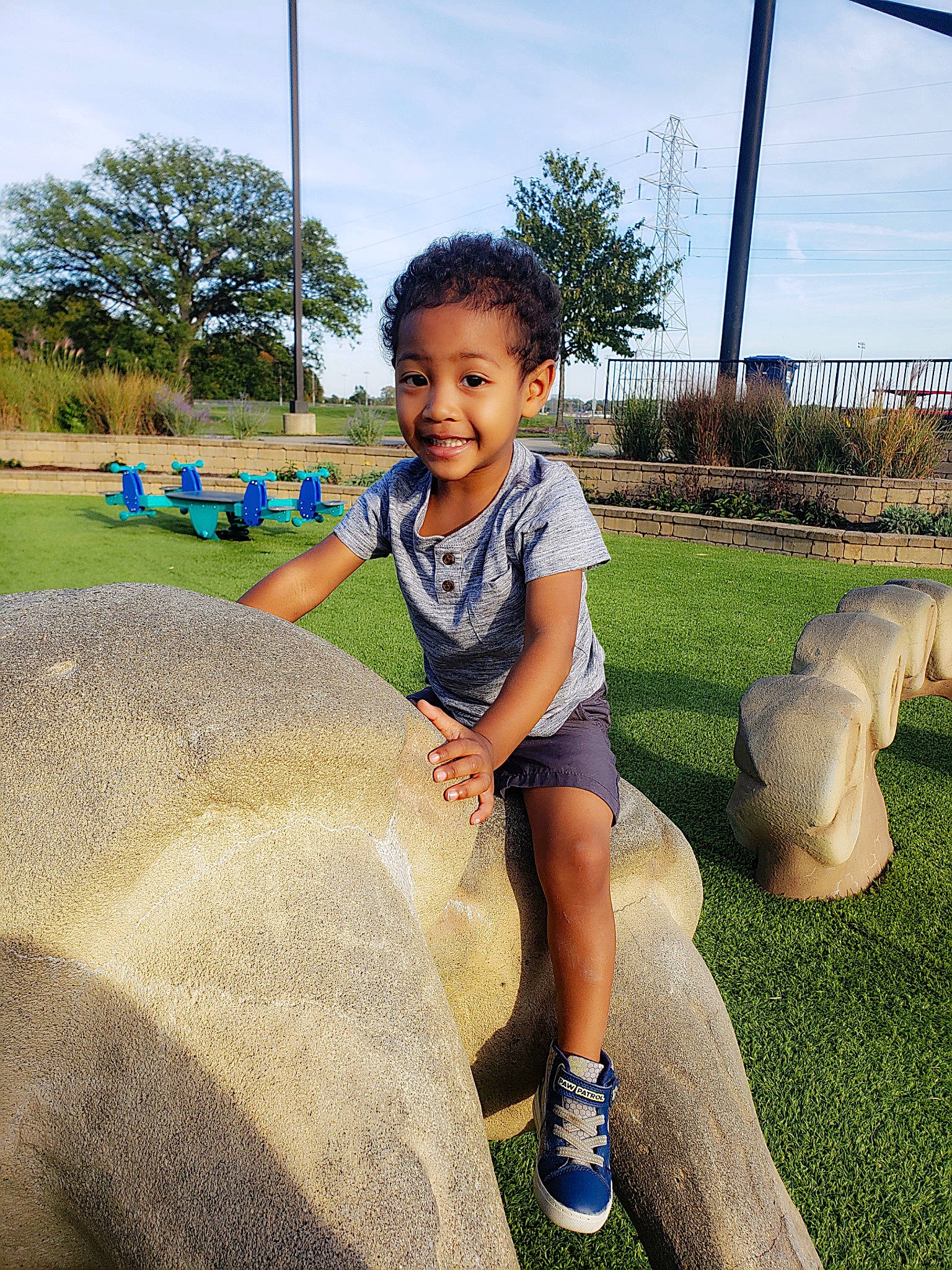 Lennox is registered to the contest to win money with this photo: child, fun, grass, grass_family, happy, human_settlement, joy, landscape, leisure, people_in_nature, person, plant, public_space, recreation, shoe, shorts, sky, smile, sneakers, t_shirt