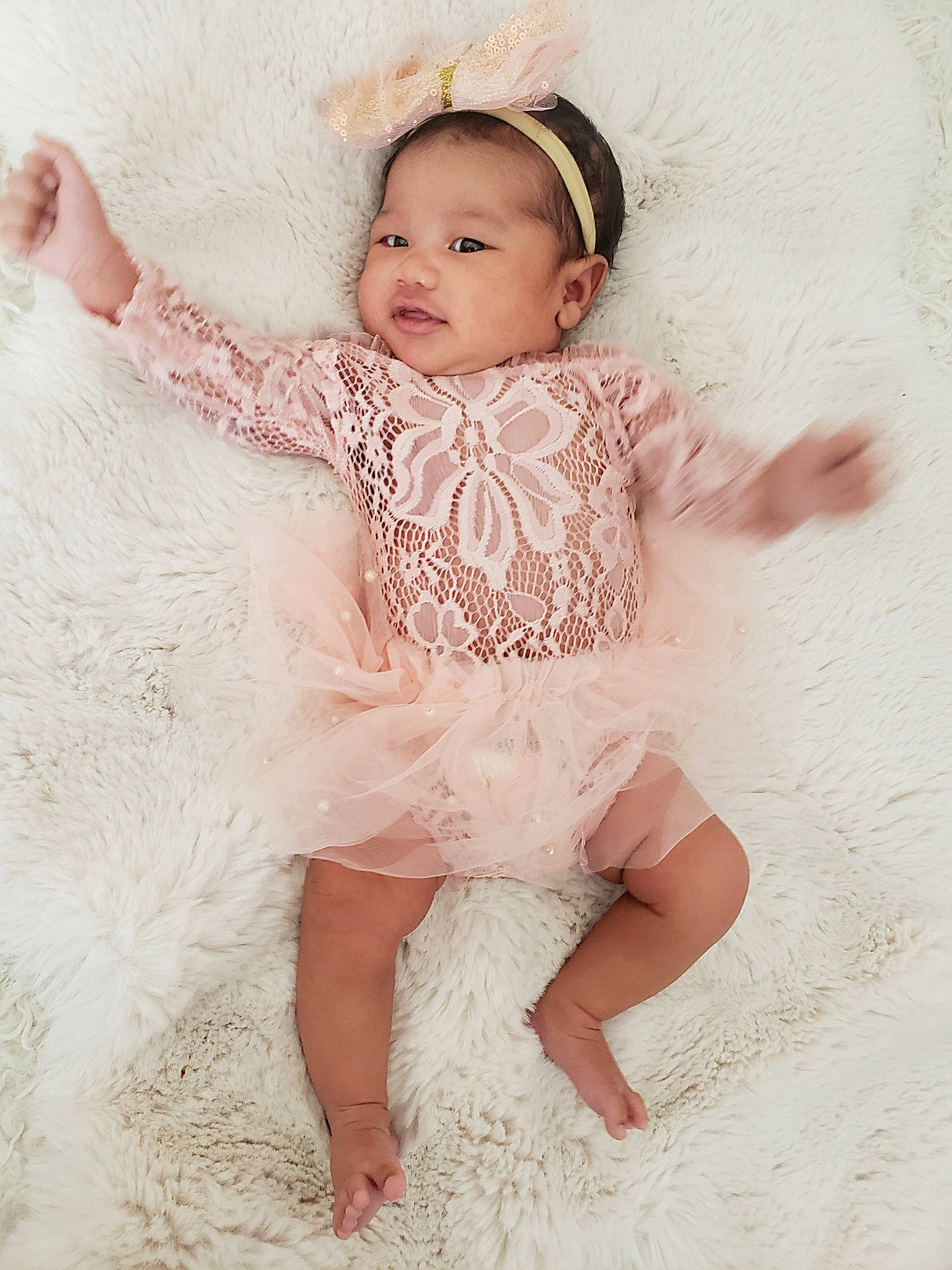 Everly joined the competition — help win amazing prizes! baby, baby_toddler_clothing, barefoot, child, embellishment, face, fashion_accessory, finger, foot, hair_accessory, happy, headband, human_leg, pattern, peach, person, pink, sitting, skin, sleeve