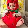 baby, blanket, chair, child, clothing, costume, cute, expression, face, foot, green, hand, indoor, infant, pattern, portrait, red, sitting, soft, strawberry