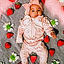 Zayla is registered to the contest to win money with this photo: baby, infant, pink_clothing, headband, bow, strawberries, flowers, blanket, soft_texture, cute, lying_down, socks, portrait, adorable, child, fresh_fruit, floral, cozy, colorful, indoors