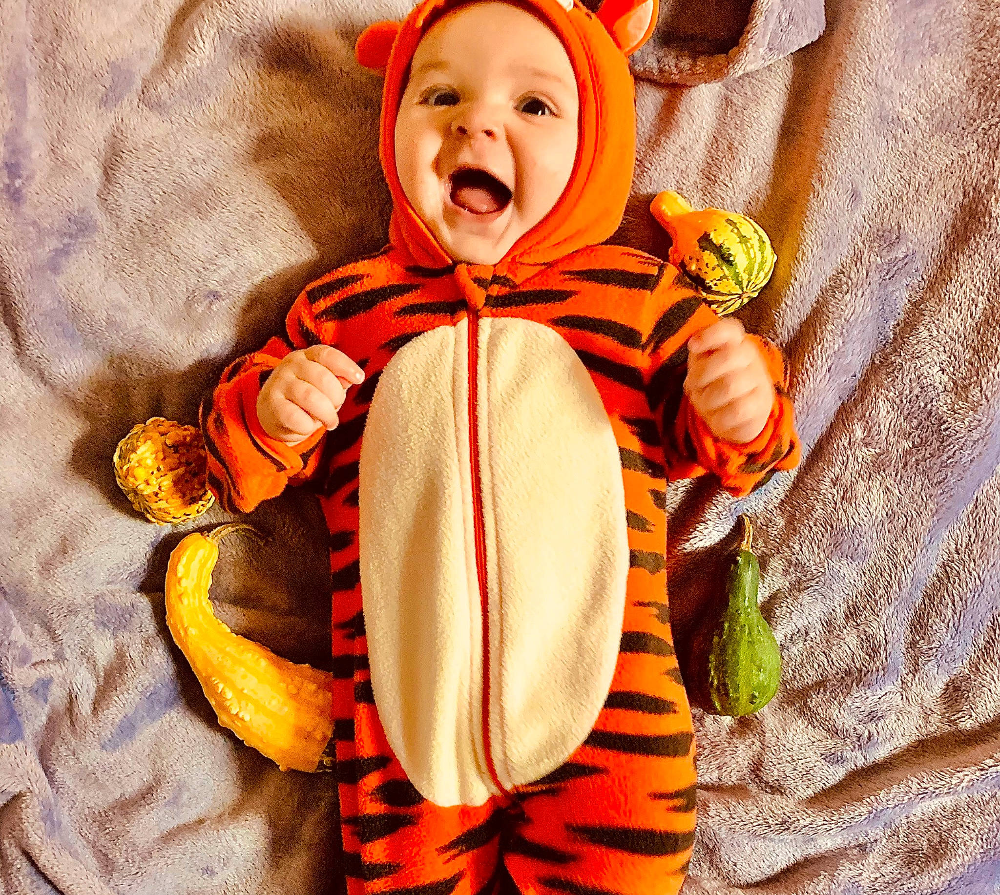 Troy is registered to the contest to win money with this photo: baby, baby_products, baby_toddler_clothing, child, collar, comfort, costume, event, fun, happy, headwear, laugh, linens, orange, pattern, peach, person, polar_fleece, scarf, sleeve