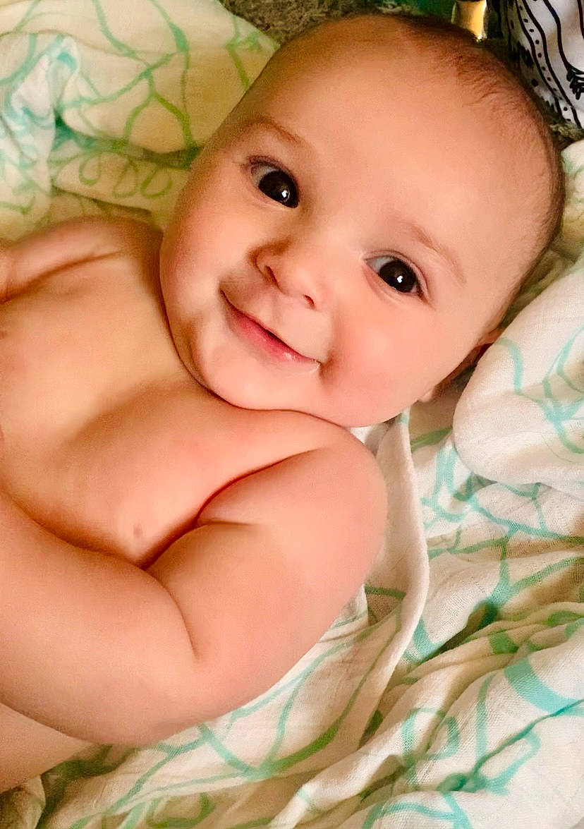 Troy is registered to the contest to win money with this photo: arm, baby, cheek, chest, chin, eye, eyebrow, eyelash, face, gesture, happy, head, human_body, iris, joy, lip, mouth, nose, person, skin