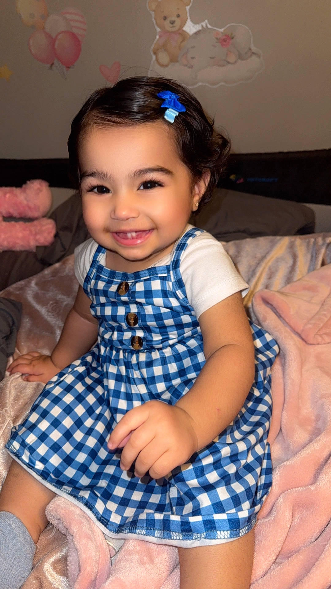 Sanaya joined the competition — help win amazing prizes! baby, blanket, blue_dress, checkered_pattern, child, cozy, cute, face, girl, hair_clip, hand, happy, indoors, portrait, sitting, skin, smiling, soft_toy, toddler, wall_art