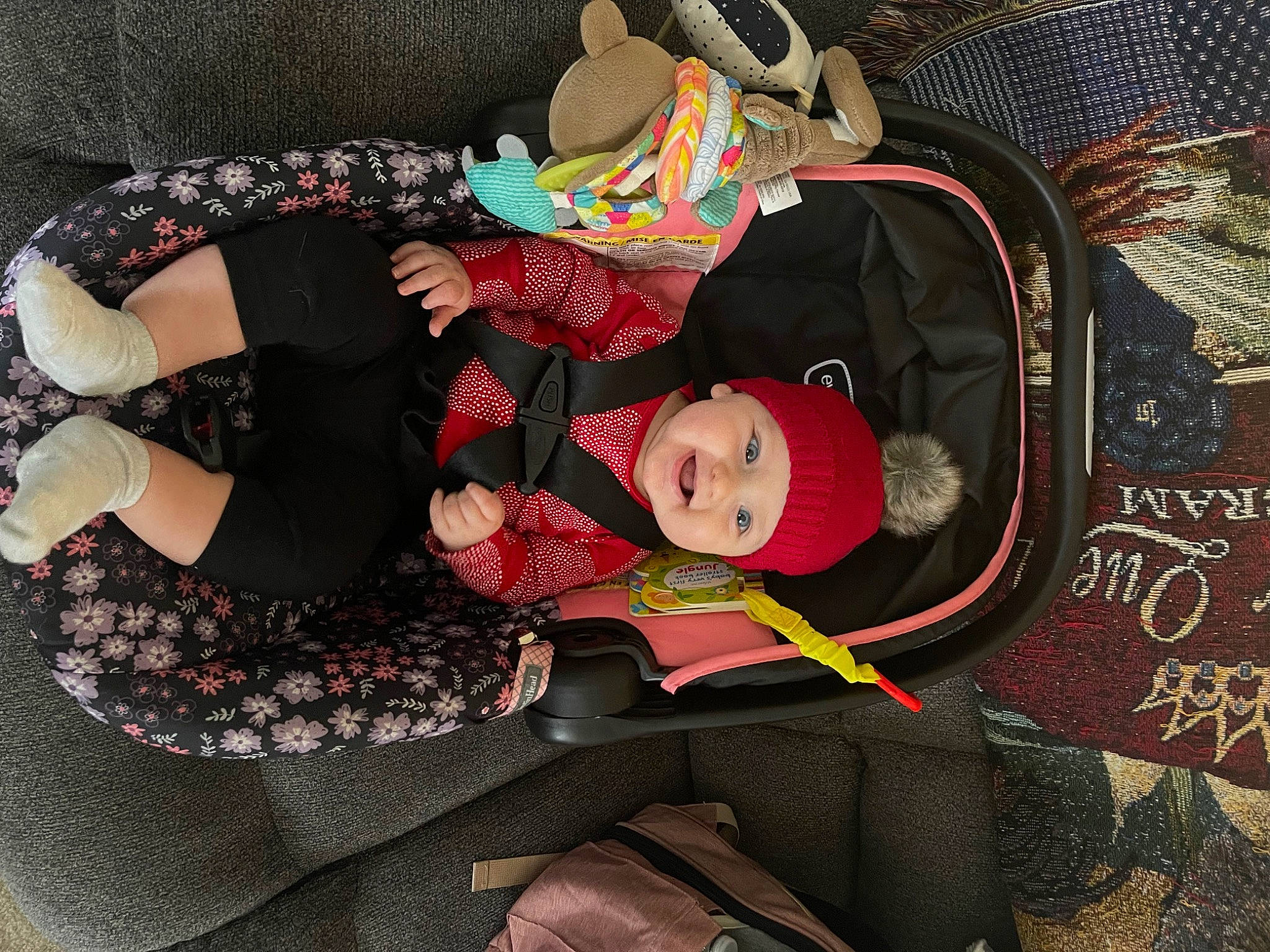 Lillian is registered to the contest to win money with this photo: art, baby, baby_carriage, baby_products, baby_toddler_clothing, carmine, child, comfort, doll, hat, headwear, lap, pattern, person, pink, room, sitting, sock, textile, thigh