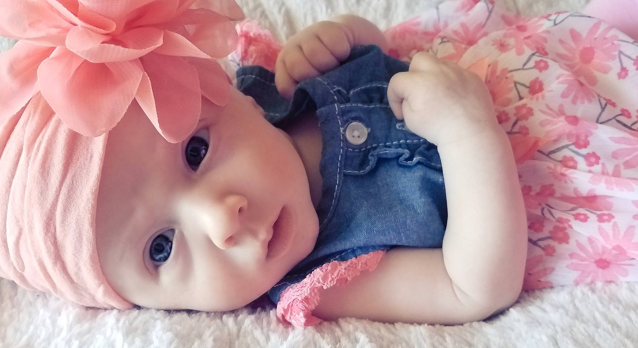 Ashlyn is registered to the contest to win money with this photo: baby, beauty, cheek, child, ear, eye, finger, hand, head, headgear, headwear, lip, mouth, nose, person, photography, pink, plant, product, skin