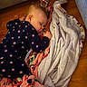 Enora joined the competition — help win amazing prizes! baby, sleeping, pajamas, star_pattern, blanket, floor, wooden_floor, pacifier, pink_shoe, child, indoor, cozy, cute, rest, toddler, soft, comfort, peaceful, infant, nap