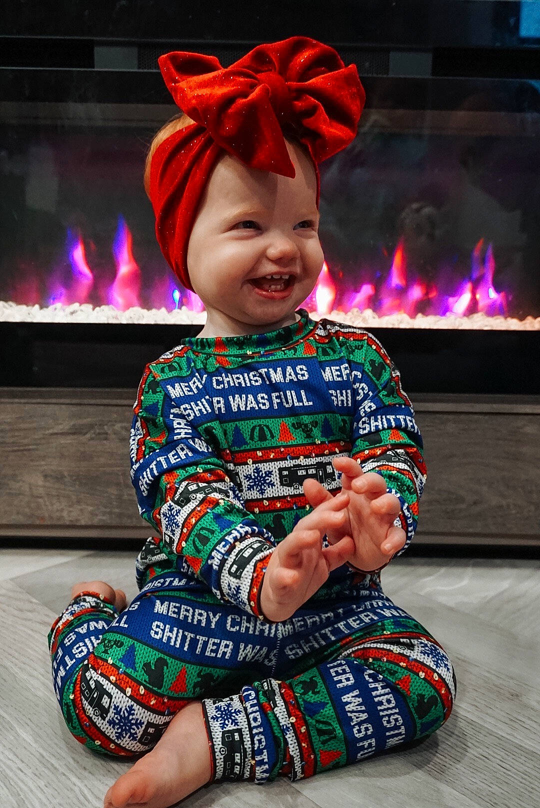 Daphne joined the competition — help win amazing prizes! cap, child, design, event, flooring, fun, gas, happy, headwear, holiday, human_leg, leisure, magenta, pattern, person, red, sitting, sleeve, smile, t_shirt