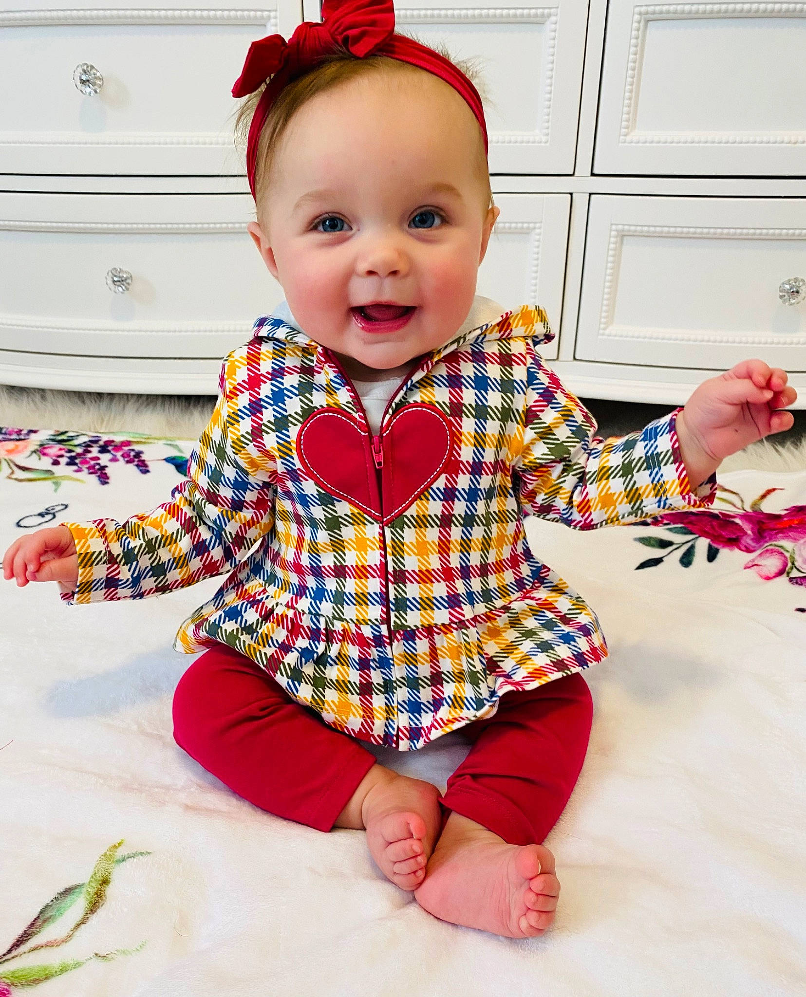 Lainey joined the competition — help win amazing prizes! baby_toddler_clothing, cabinetry, child, collar, dress, eye, facial_expression, flooring, happy, human_body, person, pink, plaid, product, sleeve, smile, standing, t_shirt, tartan, textile