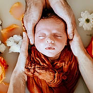 Martin participe au concours pour gagner de l'argent avec cette photo : baby, newborn, sleeping, infant, hands, adult_hands, swaddle, milk_bath, flowers, petals, portrait, closeup, skin, cozy, peaceful, studio_photography, indoor, orange_cloth, flower_bath, head
