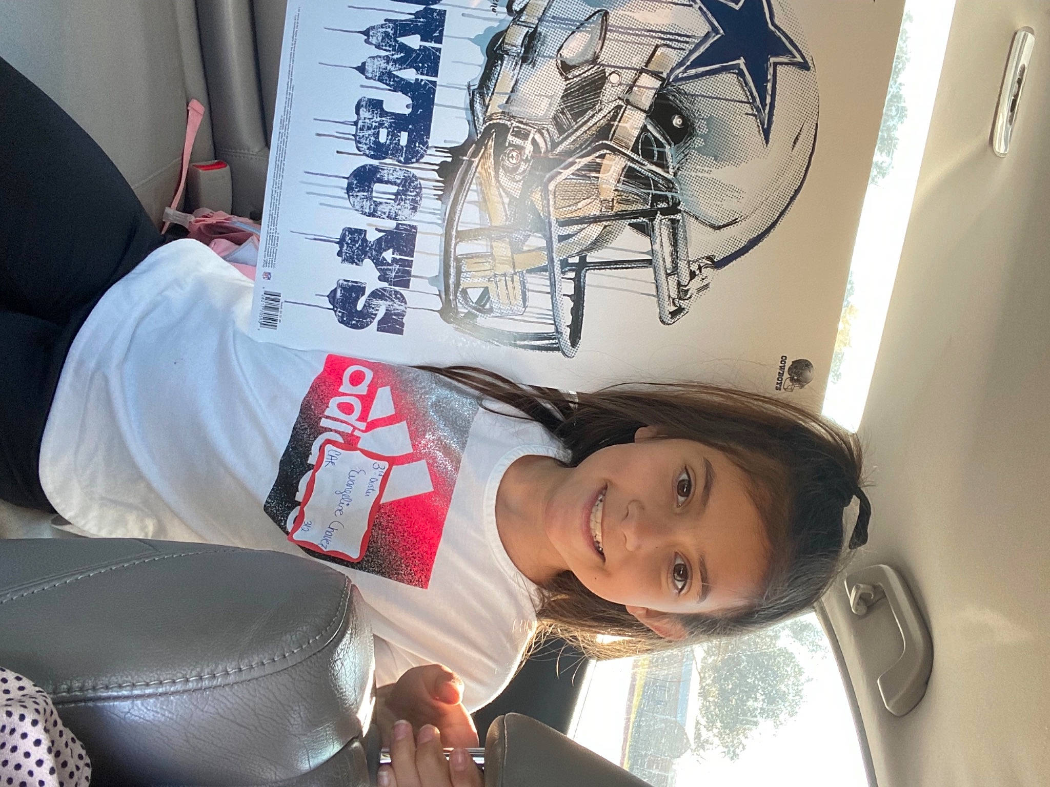 Evangeline is registered to the contest to win money with this photo: advertising, art, artist, auto_part, automotive_design, automotive_exterior, automotive_lighting, automotive_wheel_system, carmine, chair, cool, fashion_accessory, font, graphics, ink, joy, motor_vehicle, person, publication, smile