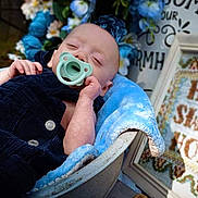Hunter is registered to the contest to win money with this photo: baby, blanket, blue, child, clothing, cozy, cute, decor, flowers, home_sweet_home, indoors, infant, pacifier, peaceful, portrait, relaxing, resting, sign, sleeping, soft_texture
