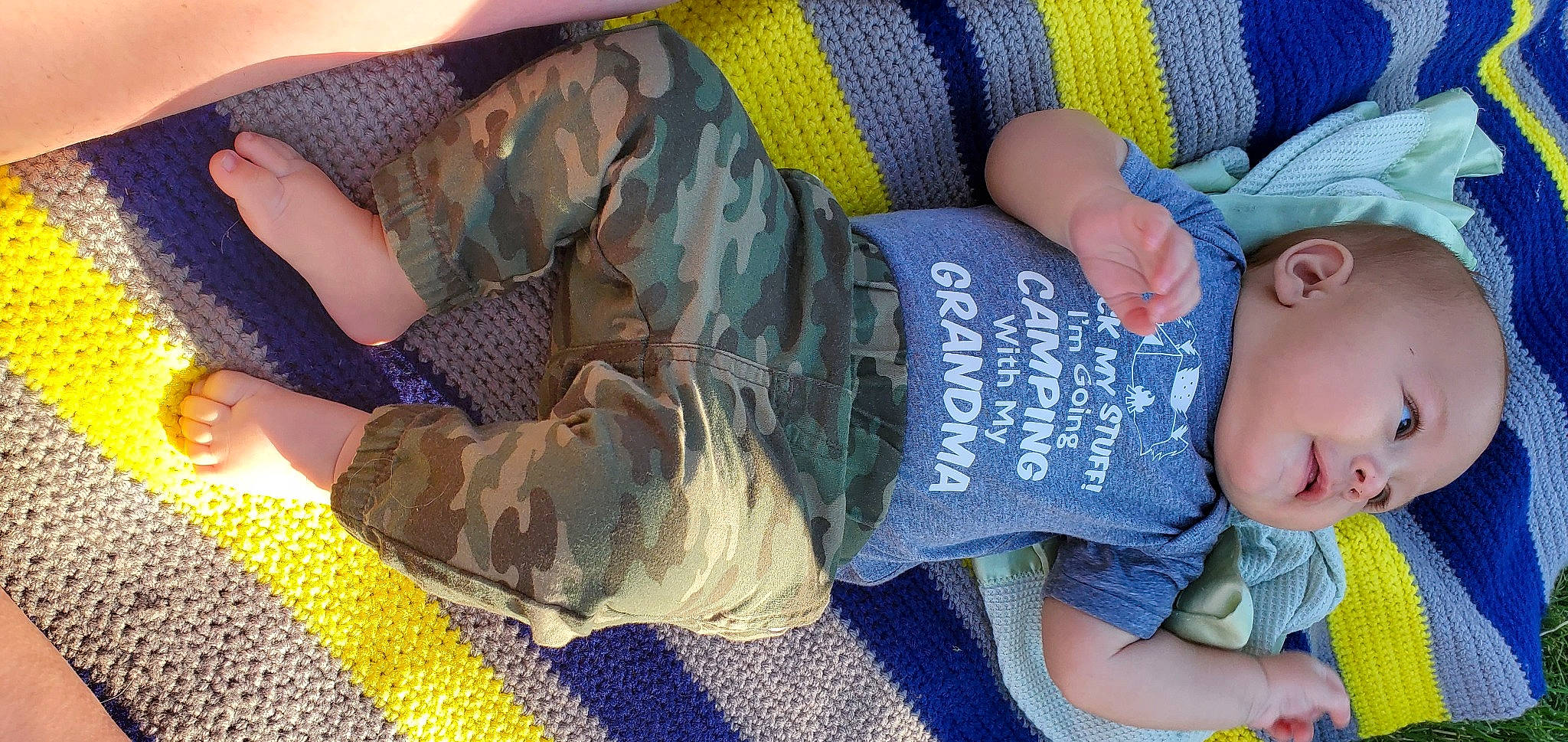 Kolby is registered to the contest to win money with this photo: child, comfort, denim, elbow, flooring, foot, fun, human_leg, joint, knee, lap, military_camouflage, nail, pattern, person, sitting, sock, thigh, toddler, tree