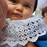 Mathéïs participe au concours pour gagner de l'argent avec cette photo : baby, black, child, closeup, clothing, cute, expression, face, hand, headwear, holding, infant, lace, outdoor, person, portrait, skin, soft, texture, white