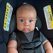 Ezra joined the competition — help win amazing prizes! baby, child, car_seat, safety_harness, warning_label, straps, curious_eyes, tongue_out, chubby_cheeks, infant, seatbelt, cute, portrait, indoor, person, clothing, head, face, young_child, expression