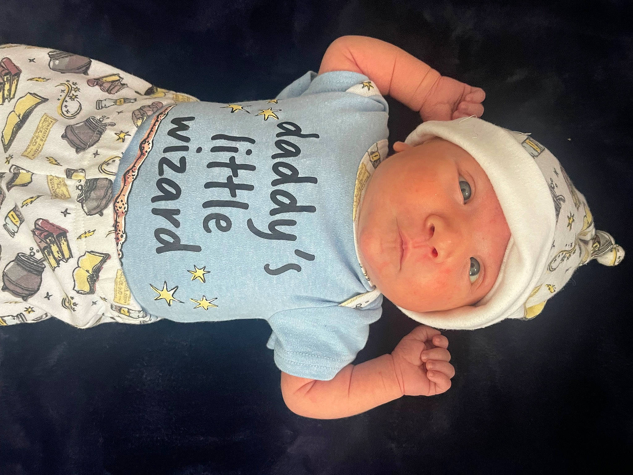 Sophia is registered to the contest to win money with this photo: abdomen, baby, baby_toddler_clothing, cap, child, elbow, fashion_accessory, finger, font, happy, hat, headgear, headwear, human_body, human_leg, pattern, person, sleeve, t_shirt, toddler