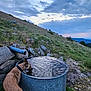 animal, clouds, dog, drinking, evening, field, grass, hill, landscape, leash, metal, mountains, nature, outdoor, pet, rocks, sky, sunset, thirsty, water_tank