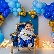 Haisbran is registered to the contest to win money with this photo: baby, child, birthday, throne, balloons, blue, gold, party, celebration, smiling, happy, royal, costume, first_birthday, decorations, light, portrait, indoors, cute, festive